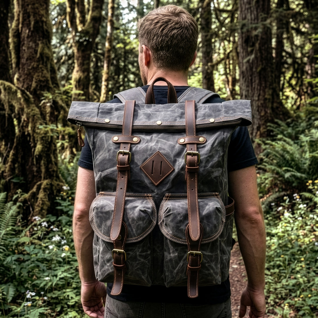 Man with a grey berlin backpack walking through a forest
