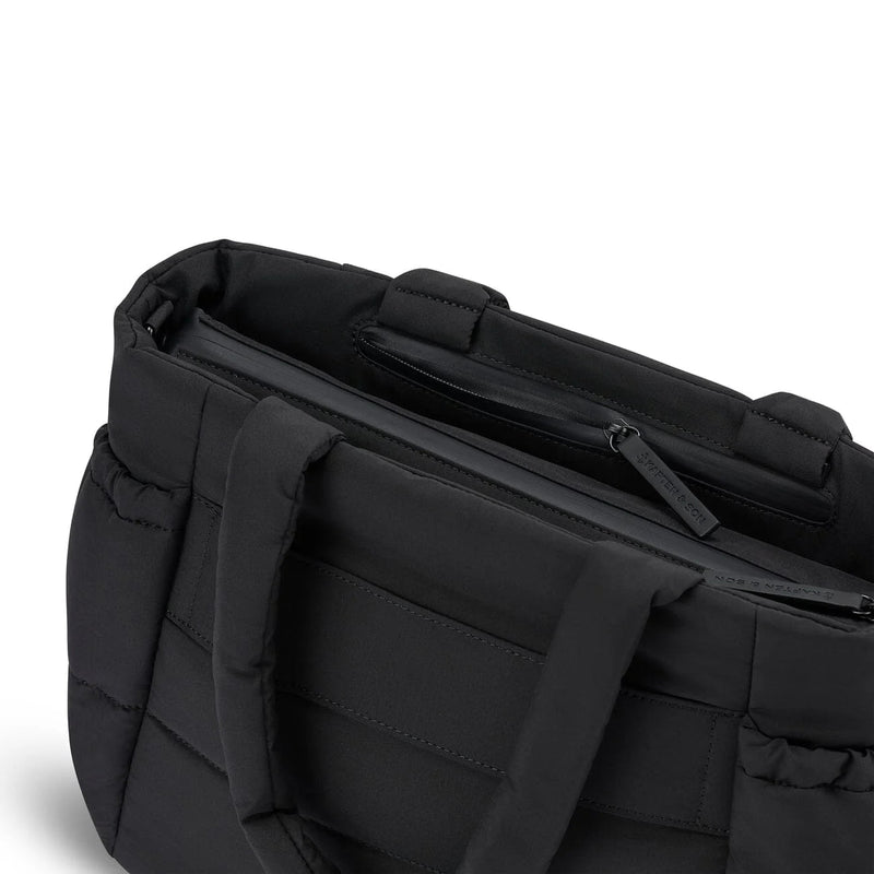 Close-up of the half-open anti-theft zip pocket at the top of the back