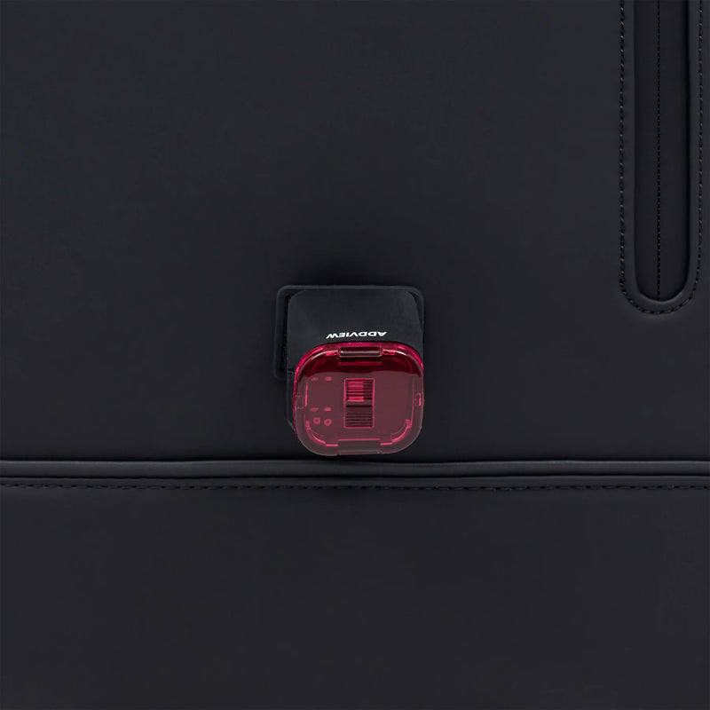 Light attachment point on the front of the black bag, shown with a red bike light (light not included)