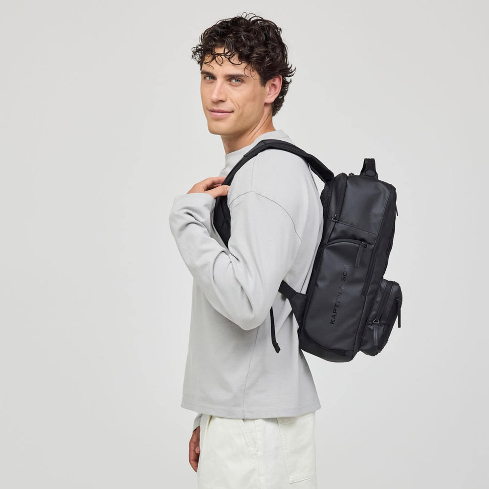 Man carrying the Bergen Ultra backpack over one shoulder, side view
