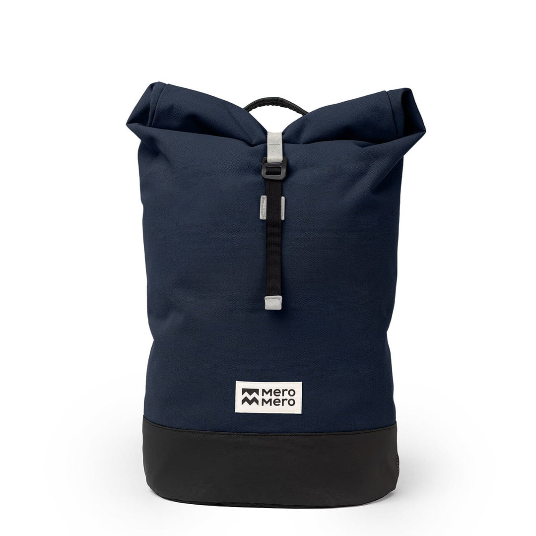 Mero Mero Wanaka Backpack in navy blue — front view with rolltop closure and side handles