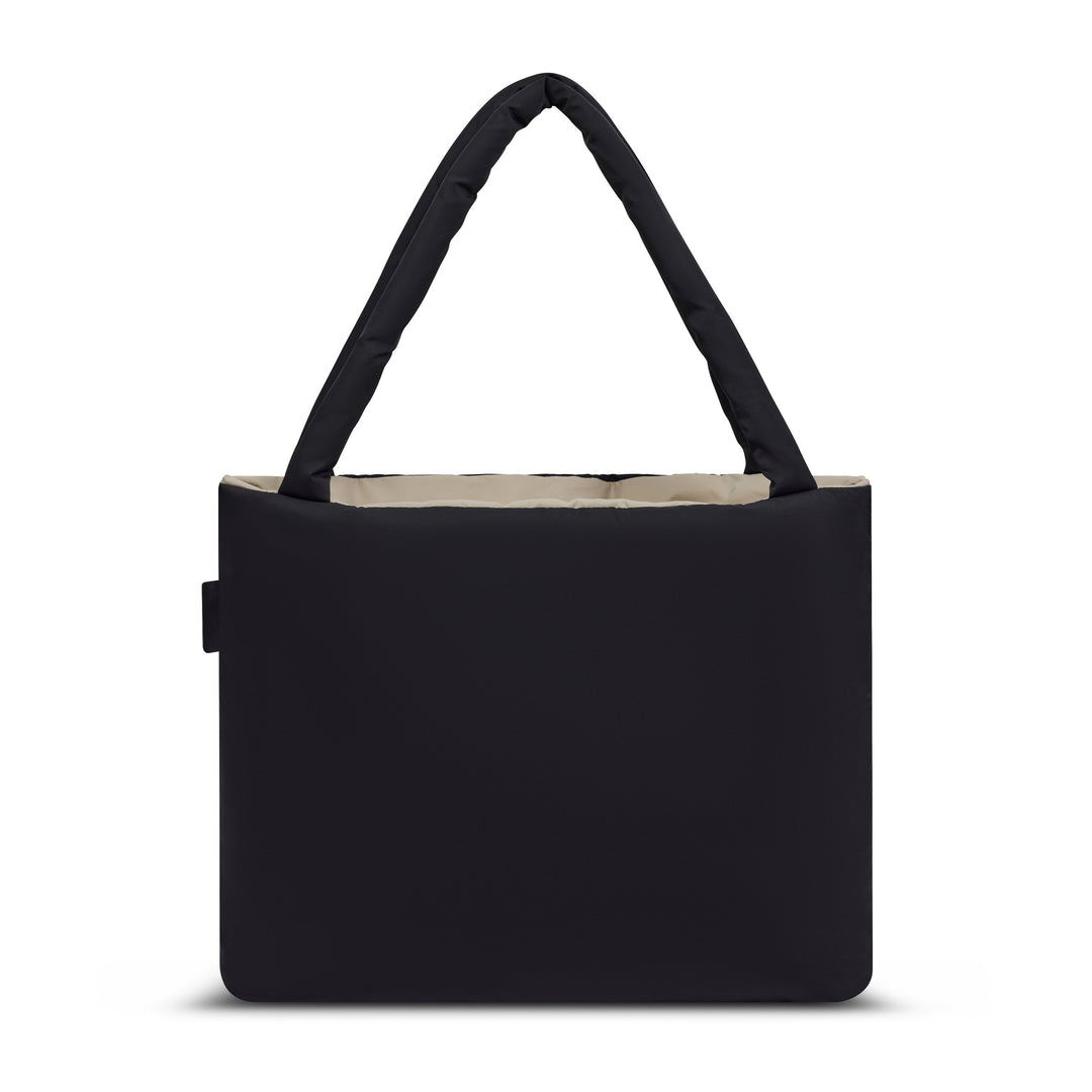 Reversible 23L shopper seen from the back, black side out, with the padded handles