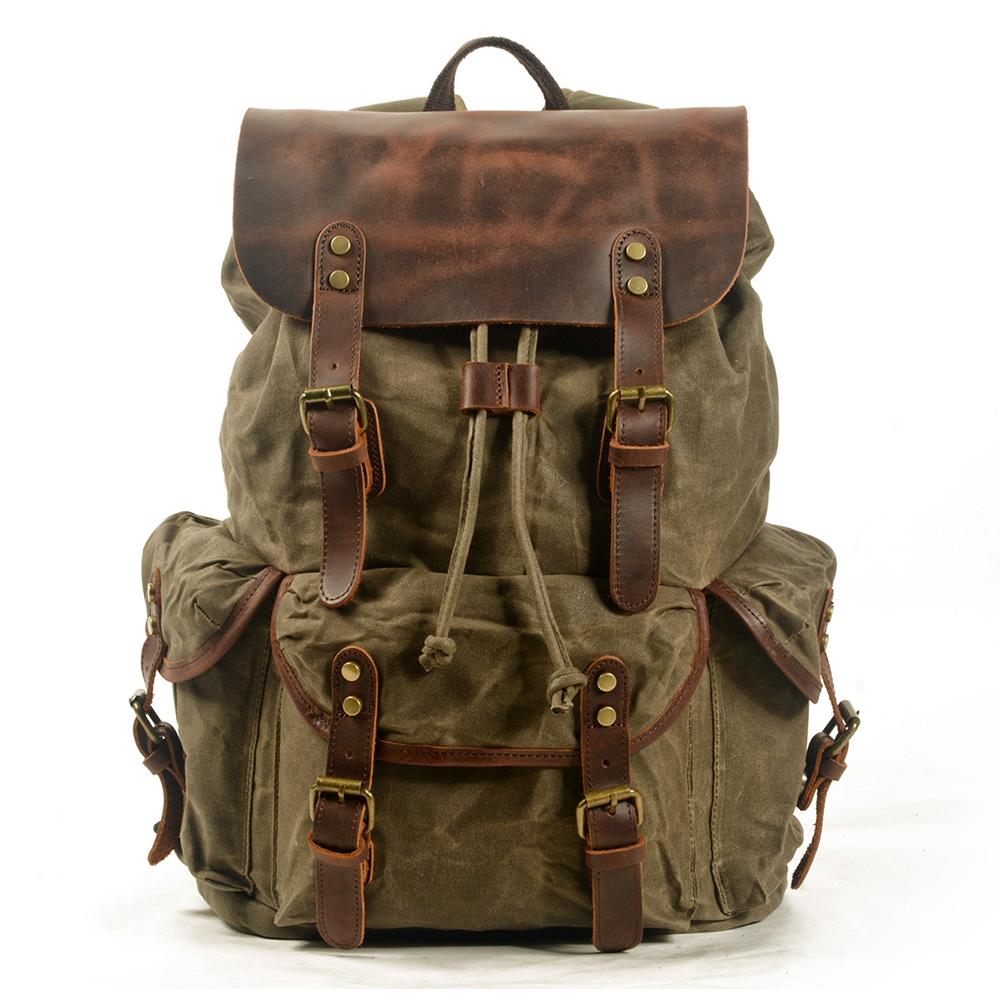 Canvas leather backpack in army green with full-grain leather flap, twin brass buckle straps and front cargo pockets — Malmö