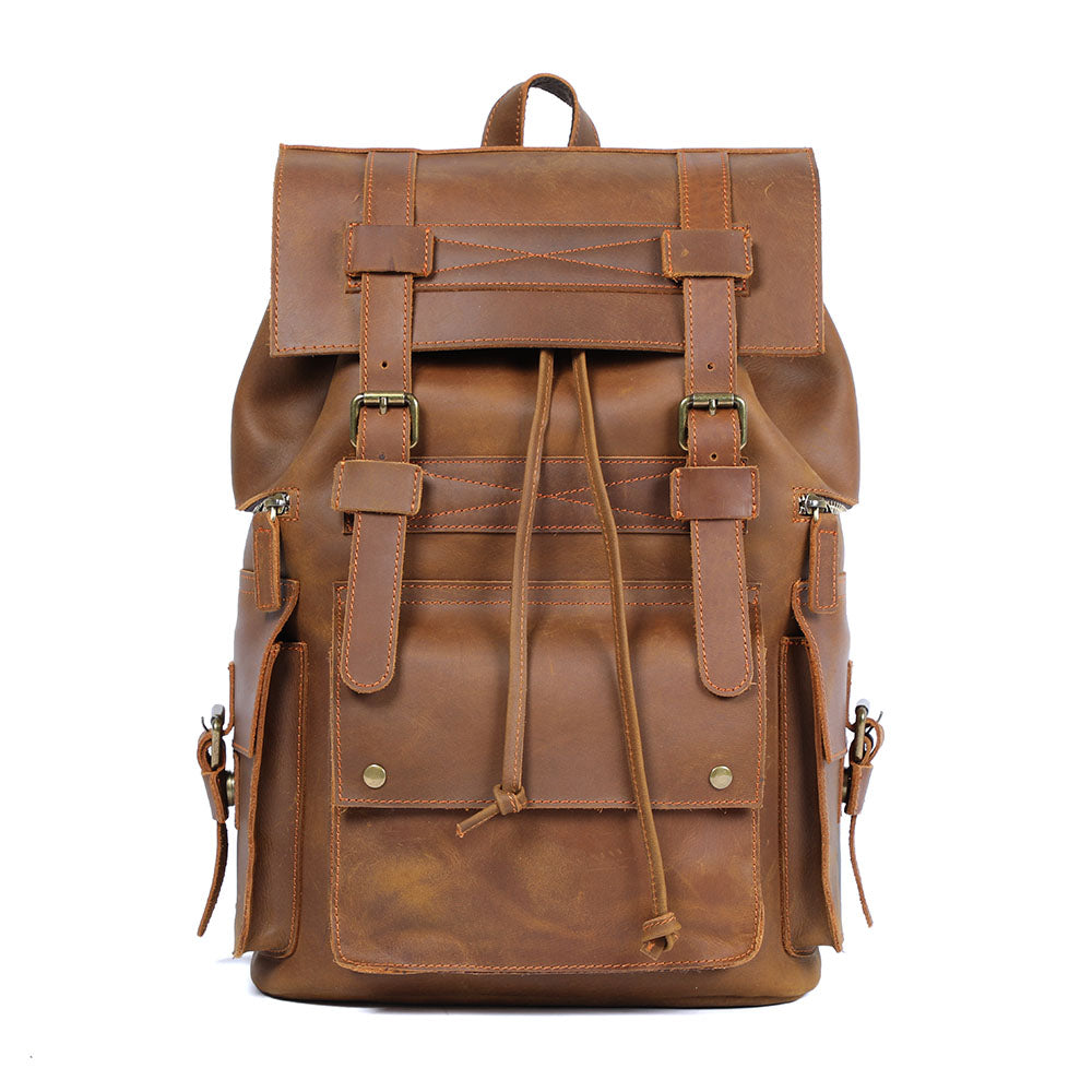 light brown full grain leather backpack, flap straps and front magnetic pocket