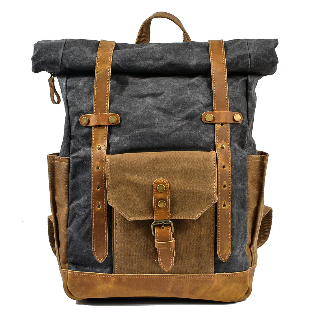 Roll top rucksack in dark grey waxed canvas with full-grain leather strap and brass buckle, tan contrast pocket panel, Eiken Copenhague model